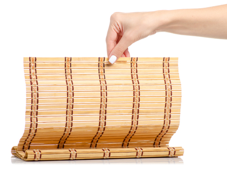 Bamboo mat natural in hand on a white background isolationの写真素材