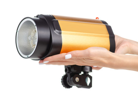 Studio flash equipment in hand isolated on a white background.