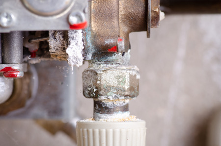 Oxidized pipes from water in a gas water boilerの写真素材