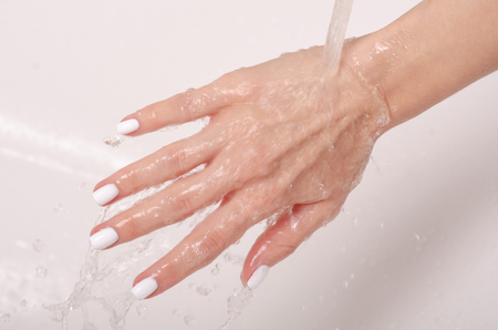 Soapy hands water faucet bathroom disinfection careの写真素材