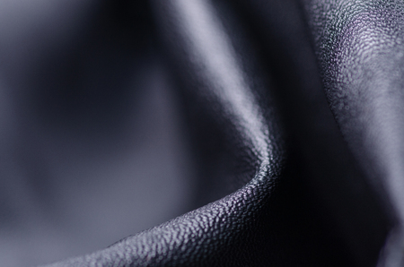 Black leather fabric textile material texture macro blur backgroundの写真素材