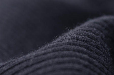 Black sweater fabric textile material texture macro blur backgroundの写真素材
