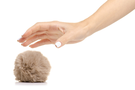 Fur ball brown in hand on white background isolationの写真素材