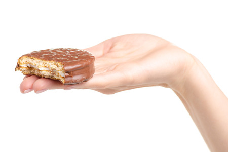Chocolate sandwich cookie in hand on white background isolationの写真素材