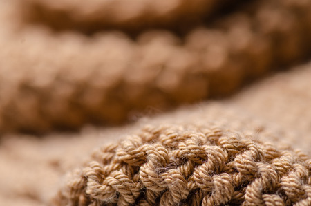 Large knit brown fabric texture textile macro blur backgroundの写真素材
