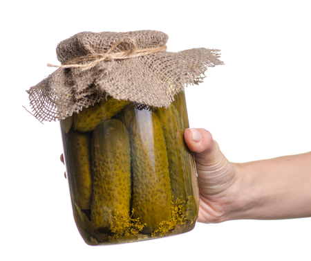 Bank of canned cucumbers in hand on a white background. Isolationの写真素材