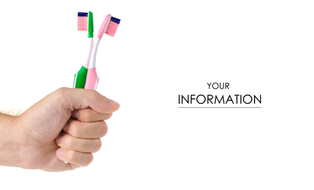 Two toothbrushes in hand pattern on white background isolationの写真素材