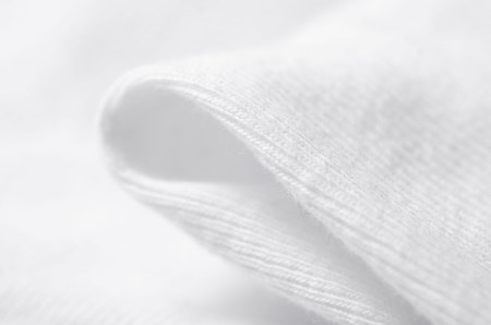 White warm fabric texture material sweater on blur background