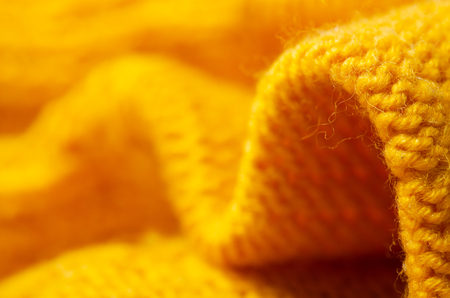 Yellow warm fabric texture material sweater on blur backgroundの写真素材