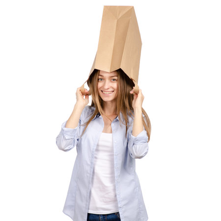 Woman with paper bag on the head isolated on white backgroundの写真素材