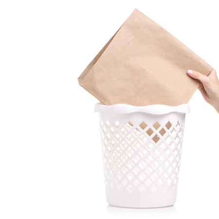 Office white bucket paper bag in hand isolated on a white background.の写真素材