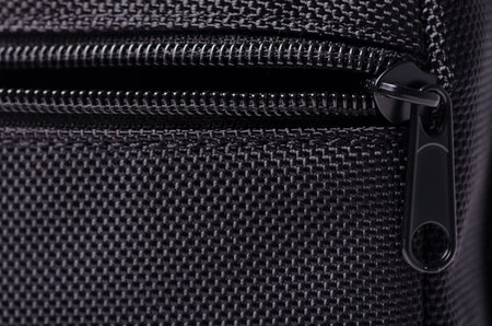 Black textile accessories material zipper metal macro on blur background