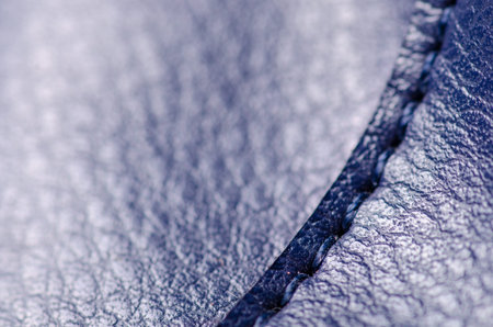Blue leather material textile fabric bag accessory firmware stitches macro on blur backgroundの写真素材