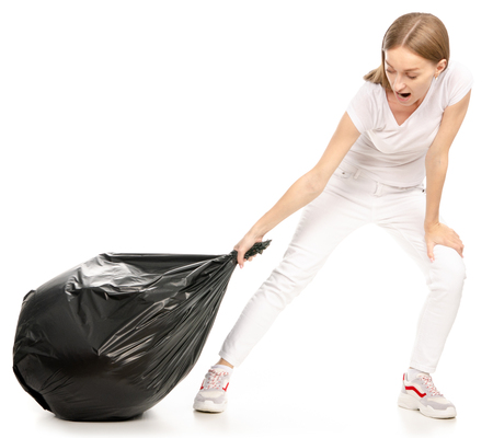 Woman in hand trash bag on a white background. Isolationの写真素材