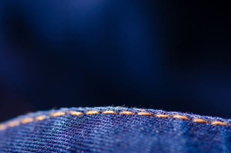 Blue jeans material fabric texture fashion seam fittings macro blur backgroundの写真素材