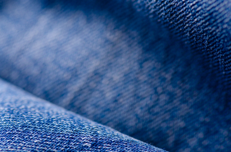 Blue jeans material fabric texture fashion seam fittings macro blur backgroundの写真素材