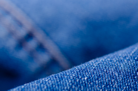 Blue jeans material fabric texture fashion seam fittings macro blur backgroundの写真素材