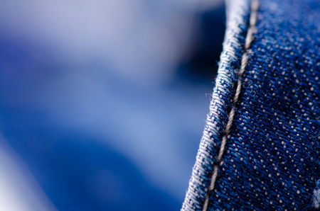 Blue jeans material fabric texture fashion seam fittings macro blur backgroundの写真素材
