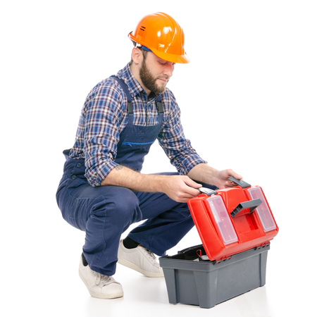 Young man builder with toolbox industry worker hardhat on white background isolationの写真素材