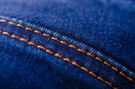 Blue jeans material fabric texture fashion seam fittings macro blur backgroundの写真素材