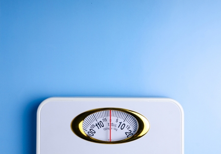 Weighing scale on blue background, top view flat layの写真素材