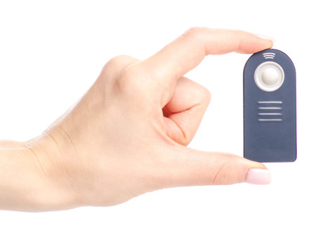 Remote control for the camera in hand isolated on a white background.の写真素材