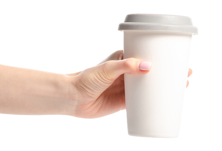 White cup mug with gray lid in hand isolated on white background.の写真素材