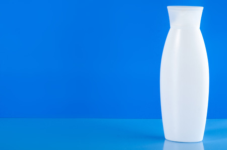 White jar of cream, gel shower, lotion beauty on blue backgroundの写真素材