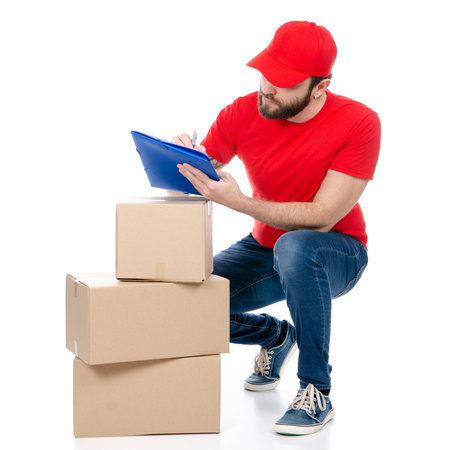 Delivery man in red uniform holding box package isolated on white background