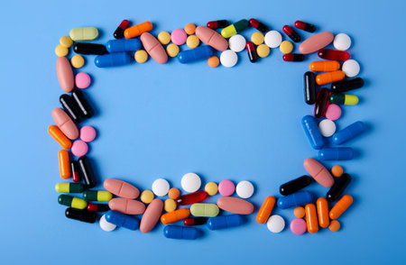 Pills capsules medicine health on blue background top view, medical pharmacy concept
