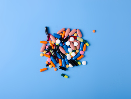 Pills capsules medicine health on blue background top view, medical pharmacy conceptの写真素材