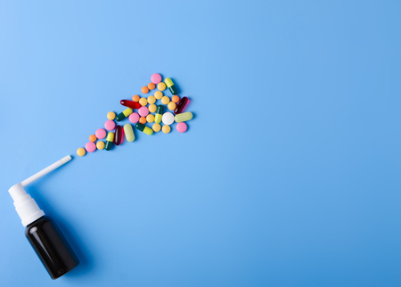 Pills capsules throat spray medicine health on blue background top view, medical pharmacy conceptの写真素材