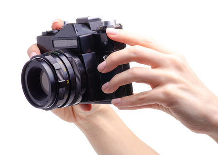 Photo camera old in hands on white background isolationの写真素材