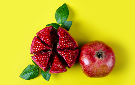 Pomegranate red fruit on yellow background, top viewの写真素材