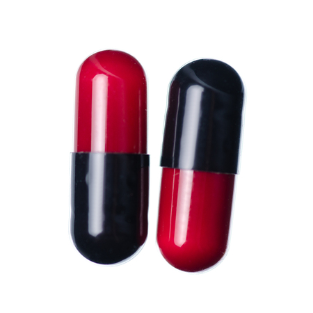 Capsule pills medicine pharmacy red black isolated on white background, top viewの写真素材