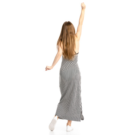 Woman in dress dancing isolated on a white background, back viewの写真素材