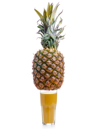 Pineapple and glass with juice isolated on a white backgroundの写真素材