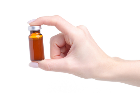 Medical glass jar in hand isolated on a white backgroundの写真素材