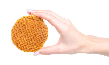 Waffles with caramel in hand isolated on a white backgroundの写真素材