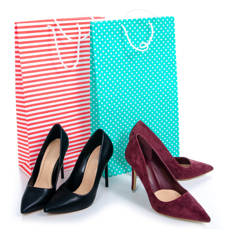 Female black and red high heels shoes shopping bags packages on a white background. Isolationの写真素材