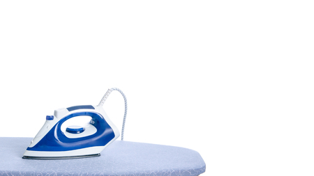 Blue iron on ironing board on a white background isolationの写真素材