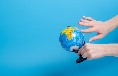 Globe world in hand on blue backgroundの写真素材