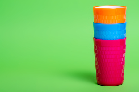 Colorful plastic cups drink on green backgroundの写真素材