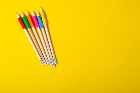 Pencils color education on color yellow background, top view
