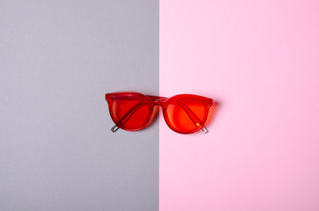 Flat lay. Sunglasses fashion on color gray pink background