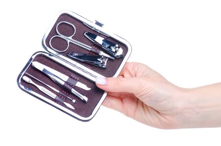 Hand holding manicure set in a case on white background isolationの写真素材