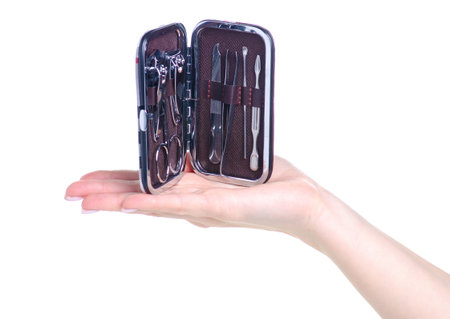 Hand holding manicure set in a case on white background isolationの写真素材
