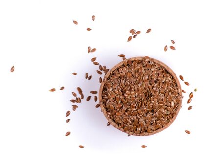flax seeds in wooden bowl on white background isolationの写真素材