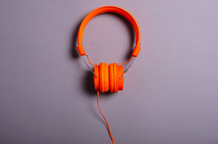 Orange headphones audio technology on gray backgroundの写真素材