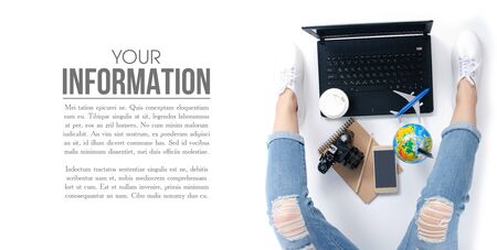 top view travel concept. Woman sitting and using laptop camera, airplane, smartphone, cup of coffee map and outfit of traveler business, pattern on white background with copy spaceの写真素材